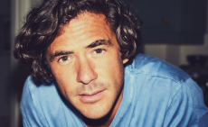 Jack Savoretti poses in a baby blue T-shirt