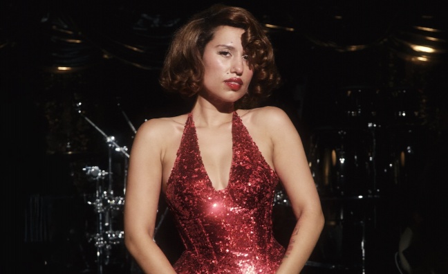 Raye in a red dress